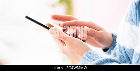 Female hands using mobile phone Stock Photo
