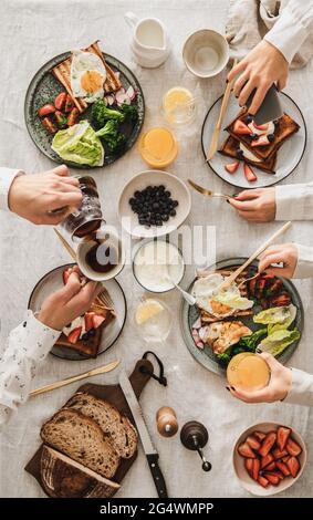 Family having breakfast or gathering dinner together Stock Photo