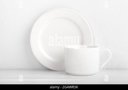 Set of cup and plate on white background Stock Photo