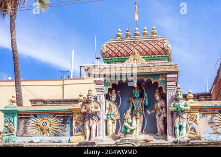 Close up of colourful garish Hindu god deity sculptures Rama and Hanuman on roof of building, Mysore, Karnataka, India Stock Photo