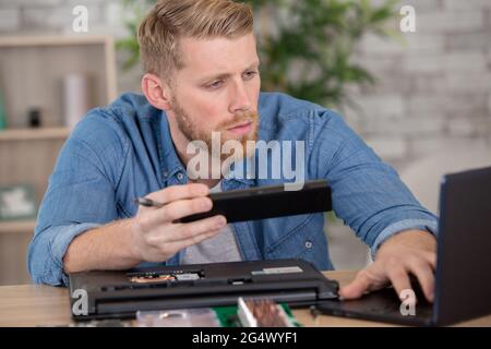 thoughtful it developer thinking about fixing software bugs Stock Photo