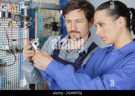 team of technicians working together on servers Stock Photo