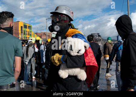 Bogota, Colombia. 21st June, 2021. A demonstrator with a Colombian flag, carries a plush bear as clashes between demonstratros and Colombia's riot police erupt anti-government protest raise in Bogota Colombia against the government of president Ivan Duque, inequalities and abuse of authority by police. Credit: Long Visual Press/Alamy Live News Stock Photo