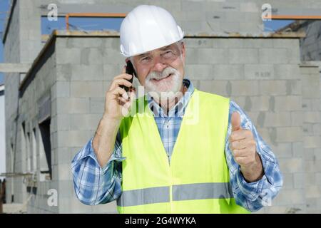 senior construction manager making thumbs-up gesture Stock Photo