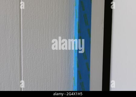 Painter's Tape On Wall Trim in Preparation for Painting Stock Photo