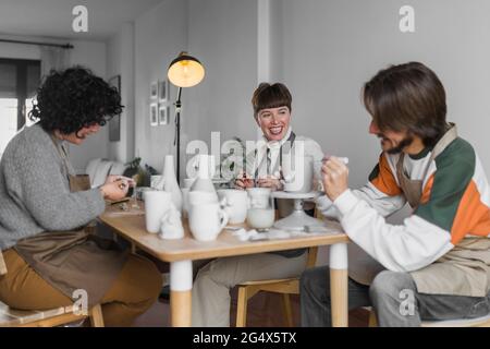 Smiling colleagues working together at workshop Stock Photo