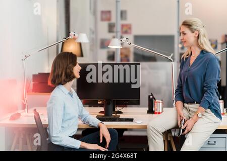 Young female professionals discussing in office Stock Photo