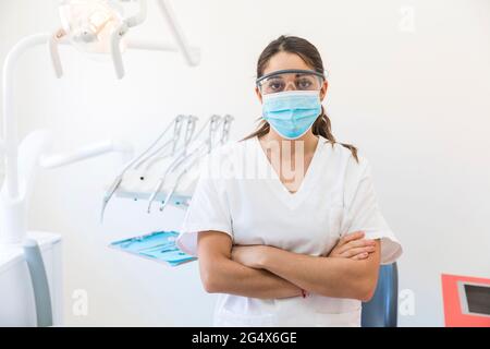 Female dentist wearing protective wear in clinic Stock Photo