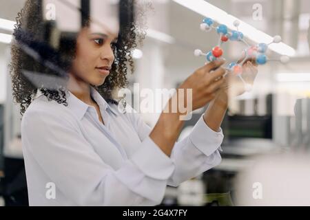Businesswoman examining molecules model in industry Stock Photo