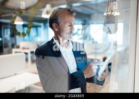 Senior businessman using digital tablet in office Stock Photo