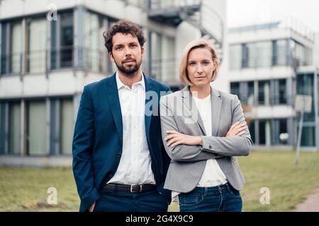 Confident business partners standing together at office park Stock Photo
