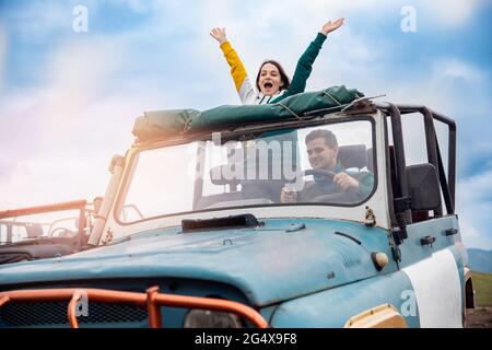 Happy man and woman travel by car in cabriolet to sea. Concept summer trip family vacation, realize dream. Stock Photo