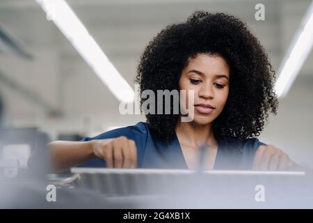 Female professional working with printing machinery in industry Stock Photo