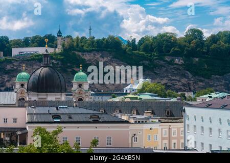 Austria, Salzburg State, Salzburg, Residential buildings in front of Holy Trinity Roman Catholic Church Stock Photo