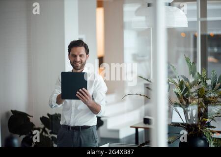 Male entrepreneur using digital tablet at office Stock Photo