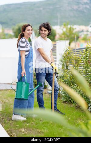 Smiling mid adult couple standing in garden Stock Photo