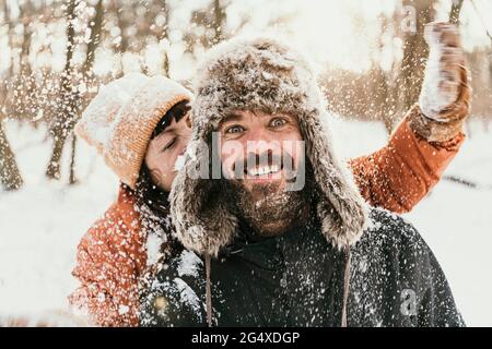 Couple having fun in forest during winter Stock Photo