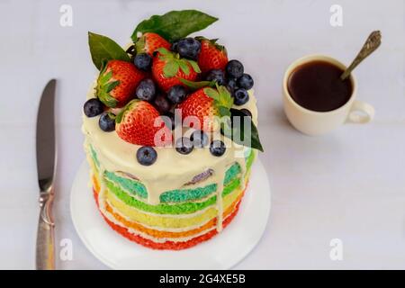 Multicolored sponge cake decorated with fresh berries. Stock Photo
