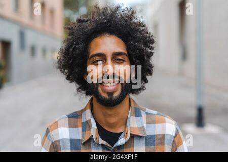 Young man with afro hairstyle smiling Stock Photo