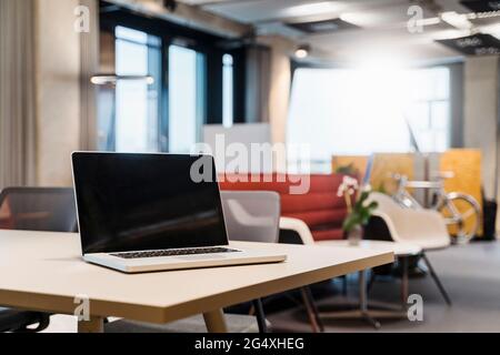Laptop placed on desk in creative office Stock Photo