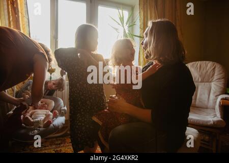 Cheerful mother and father playing with cute siblings while having fun together in room at home Stock Photo
