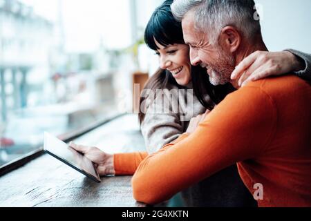 Mature couple using digital tablet in coffee shop Stock Photo