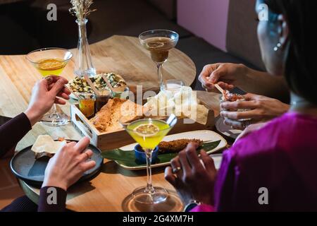 Friends having food and drink at restaurant Stock Photo