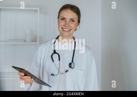 Smiling doctor holding digital tablet Stock Photo