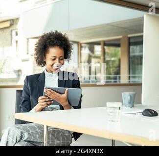Female entrepreneur using digital tablet at office Stock Photo