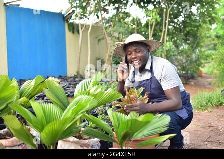 an african florist making receiving a phone call Stock Photo