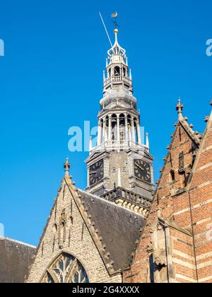 Top of the Old Church (Oude Kerk) in main red light district in Amsterdam, Netherlands, under blue sky Stock Photo