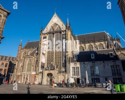 AMSTERDAM - OCTOBER 2: Tourists in front of the Nieuwe kerk (New church) located on Dam square. The building is used for exhibition space and as museu Stock Photo