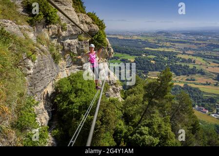 Climbers ascending the Baumes Corcades via ferrata in Centelles (Osona, Barcelona, Catalonia, Spain) ESP: Escaladores subiendo por una via ferrata Stock Photo