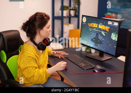 Esport of pro gamer playing video game with new graphics winning  championship, stylish design cyber games room. Virtual shooter game in  cyberspace, esports player performing on pc gaming tournament Stock Photo 