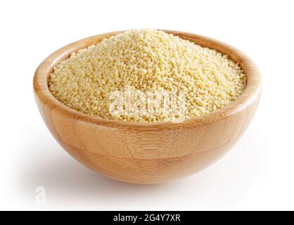 Uncooked dried couscous in wooden bowl isolated on white background with clipping path Stock Photo