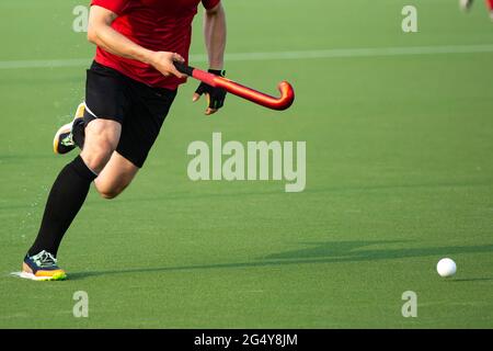 Field hockey player on artificial grass play field. Stock Photo