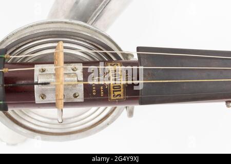 close up of fretboard of A Stroh violin or phonofiddle or stroviol musical recording instrument on a white studio background Stock Photo