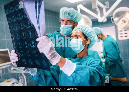 Exhausted surgeons at the emergency room as a sign of stress and overwork Stock Photo