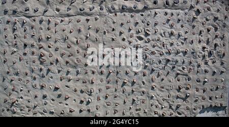 Concrete wall with decorative stones background. Concrete texture background. Granite stones pattern. Stock Photo