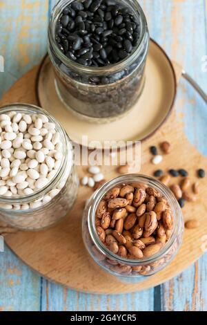 Variety of legumes in glass jars. Healthy eating ingredients, natural protein food Stock Photo