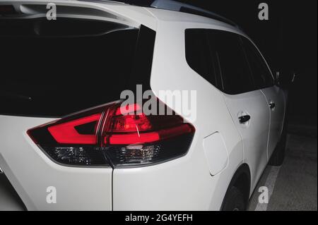 Back of white suv car with red rear lights close up view Stock Photo