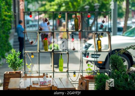 wine bottles and bulb on the street in a metal holder. Stock Photo