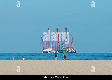 Kijkduin beach, The Hague, The Netherlands - June 13 2021: Heavy industry wind turbine installation barge off the Dutch coast, building an offshore wi Stock Photo