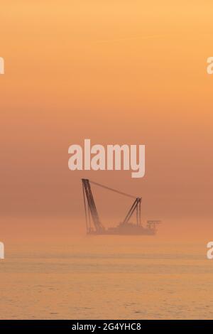 A wind turbine installation barge off the Dutch coast, building an offshore wind park for wind energy Stock Photo