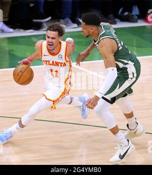 Milwaukee, USA. 24th June, 2021. The Atlanta Hawks' Trae Young (11) drives past the Milwaukee Bucks' Giannis Antetokounmpo on his way to the basket in Game 1 of the NBA Eastern Conference Finals on Wednesday, June 23, 2021, at the Fiserv Forum in Milwaukee. The Hawks won, 116-113. (Photo by Curtis Compton/Atlanta Journal-Constitution/TNS/Sipa USA) Credit: Sipa USA/Alamy Live News Stock Photo