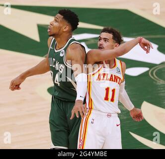 Milwaukee, USA. 24th June, 2021. The Atlanta Hawks' Trae Young (11) watches his shot drop against the Milwaukee Bucks' Giannis Antetokounmpo (34) to take a 96-94 lead in the fourth quarter in Game 1 of the NBA Eastern Conference Finals on Wednesday, June 23, 2021, at the Fiserv Forum in Milwaukee. The Hawks won, 116-113. (Photo by Curtis Compton/Atlanta Journal-Constitution/TNS/Sipa USA) Credit: Sipa USA/Alamy Live News Stock Photo