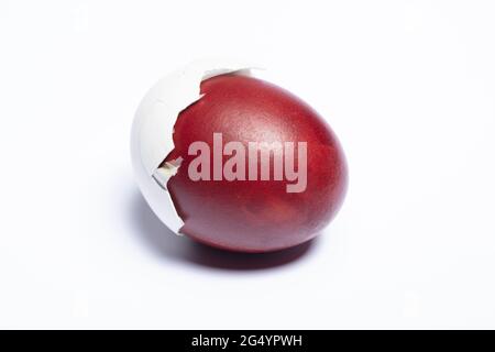Classic easter egg painted with onion peel close-up on a white background Stock Photo