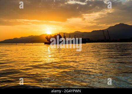 Beautiful sunset on the sea, view of the seaport Stock Photo