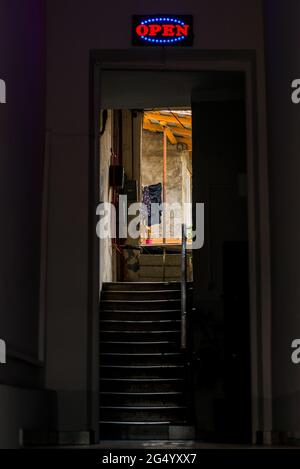 Red open neon sign glowing in the night. Stock Photo