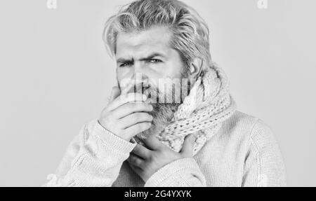 cough and runny nose first symptoms. brutal male get flu in winter. warm up with knitwear. bearded hipster sick. coronavirus from china. prevent virus Stock Photo